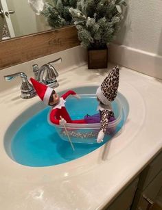 an elf is sitting in the bathroom sink