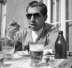 a man sitting at a table eating food