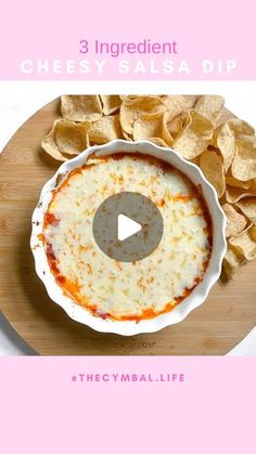 the recipe for cheesy salsa dip is displayed on a wooden platter with chips