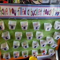 a bulletin board with buckets hanging on it