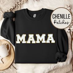 This Mama Sweatshirt, adorned with a glittering Chenille Patch and Varsity lettering, is the ultimate Mama gift, perfect for celebrating Mother's Day, birthdays, or baby showers. Elevate mom's style with this unique and thoughtful sweatshirt featuring sparkling Chenille letters, making it a dazzling and meaningful addition to her wardrobe. 🌟 Colors may appear slightly different in person versus on the computer screen and our photos all show natural lighting.     🌟 The patches are heat pressed on and all designs are hand placed, therefore there may be a slight difference in positioning of the design than the ones pictured. Patches are approximately 8cm in size (height). 🌟 We offer several sweatshirt colors and 1 patch color. For other patch colors, check out our other listings: Light Pin Mama Chenille Sweatshirt, Graphic Print Sweatshirt For Birthday And Mother's Day, Mother's Day Birthday Graphic Print Sweatshirt, Gold Tops With Letter Print For Gifts, Black Graphic Print Sweatshirt For Birthday, Washing And Drying Machine, Mama Crewneck, Chenille Patch, Cadeau Baby Shower