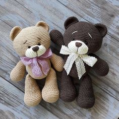 two brown teddy bears sitting next to each other on a wooden floor, one with a bow tie