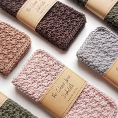 the crocheted dishcloths are lined up on top of each other in different colors