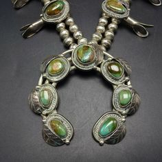 "VINTAGE NAVAJO SQUASH BLOSSOM NECKLACE DESCRIPTION: This necklace features exquisite specimens of Royston turquoise set in heavy gauge vintage sterling silver. Applied leaves frame each of the turquoise cabochons. This outstanding necklace will be a valuable addition to your collection of fine vintage Native American jewelry. MEASUREMENTS: Necklace measures 28\" end to end Naja measures 3 1/8\" x 3\" Beads are securely strung on silver foxtail chain WEIGHT: 241.0 grams SIGNED: no STERLING: unma Vintage Gemstone Jewelry For Jewelry Making, Vintage Green Rectangular Necklace, Rectangular Turquoise Jewelry For Collectors, Collectible Rectangular Turquoise Jewelry, Vintage Sterling Silver Turquoise Necklace With Patina, Vintage Turquoise Necklace With Patina, Antique Turquoise Gemstone Jewelry, Vintage Sterling Silver Necklace With Patina, Vintage Patina Pendant Jewelry