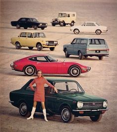 a woman standing next to two cars in a parking lot