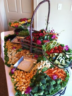 an assortment of fruits and vegetables arranged on a buffet table for a wedding or bridal party