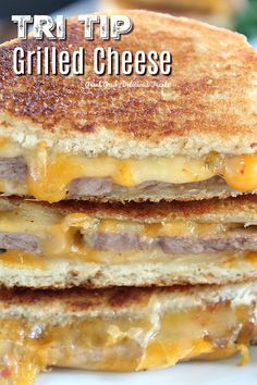 three grilled cheese sandwiches stacked on top of each other with melted cheese and meat