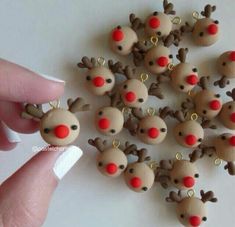 a hand is holding a bunch of tiny reindeers