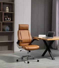 a brown office chair sitting in front of a laptop computer on top of a wooden desk