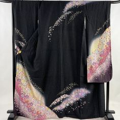 Cover yourself in flowers wearing this traditional Japanese silk Furisode kimono in black.    Made of high quality silk threads.  Beautiful on or as a room display too. Item: Furisode Silk Kimono No. frs178 Size: US  L   /  Length 64.7 inch (164.5cm), Width 27 inch (69cm). Design :  Floral Condition: Used, Very Good. Please check the photos. Need a Obi sash to wear this kimono? Find it here: https://www.etsy.com/shop/KimonoFujiyamarock?ref=simple-shop-header-name&listing_id=1418707729&section_id Traditional Black Kimono With Floral Print, Traditional Black Floral Print Kimono, Kimono Mom, Kimono Girl, Furisode Kimono, Wedding Kimono, Silk Kimono Robe, Black Kimono, Japanese Silk