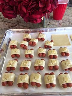 there are many hotdogs on the tray ready to be cooked in the oven