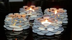 three candles are made out of rocks on a table