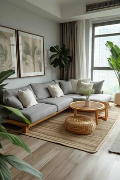 a living room filled with furniture and large windows