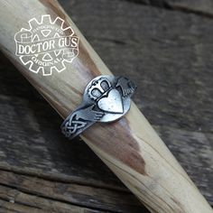 Here is a fantastic Doctor Gus original ring. This ring features a Claddagh design. Wear this ring to make a statement everyday. Or get one to add that perfect final touch to your next renaissance costume. Each one is unique and sure to start a conversation! This ring is a Doctor Gus original! That means I sculpted it myself by hand. Then I cast and finish each and every one right here in my Pennsylvania workshop. Every single ring I make is 100% handcrafted in the USA! ------------------------- Symbolic Hand Cast Adjustable Rings, Handmade Medieval Style Rings Ideal For Gifts, Handmade Medieval Style Rings As Gift, Handmade Medieval Style Rings For Gifts, Medieval Style Handmade Rings As Gifts, Medieval Style Handmade Rings For Gifts, Symbolic Hand-forged Engraved Ring As A Gift, Symbolic Hand Forged Engraved Ring For Gift, Symbolic Hand Forged Engraved Ring As Gift