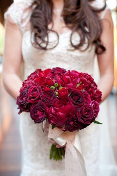 a woman in a wedding dress holding a bouquet of flowers on her cell phone screen