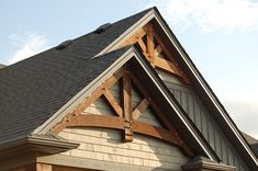 the roof of a house with a wooden cross on it