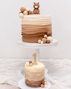 two tiered cake with teddy bears on top