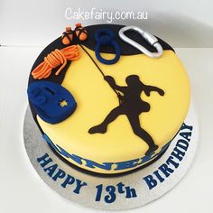 a birthday cake decorated with an image of a man holding a rope and climbing gear