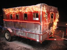 a red and silver trailer with lights on it