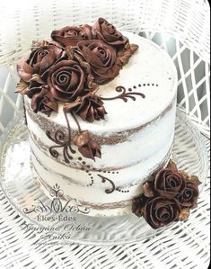 there is a white cake with brown flowers on it