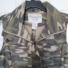 Nwot - Never Been Worn Camo Vest, Military-style Camouflage Utility Jacket With Multiple Pockets, Military Camouflage Outerwear With Buttons, Military Camouflage Windbreaker For Outdoor, Military Hunting Vest With Pockets, Military Camouflage Hooded Jacket For Outdoor, American Rag, Camo, Jackets & Coats