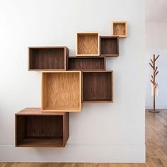 a wall mounted shelf with wooden shelves on it