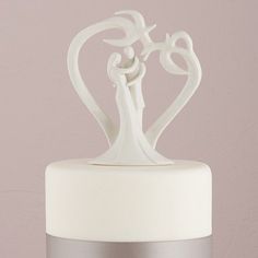 a wedding cake topper in the shape of a bride and groom