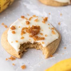 a cookie with white frosting and orange sprinkles is cut in half