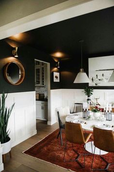 a dining room table with chairs and a rug on the floor in front of it