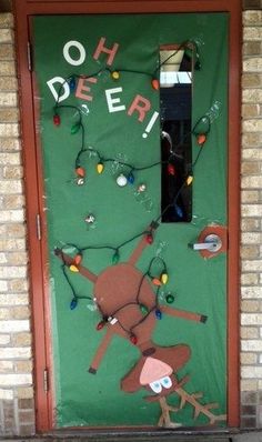 a door decorated with christmas lights and an image of a monkey on the front porch