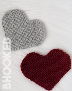 two crocheted hearts sitting next to each other