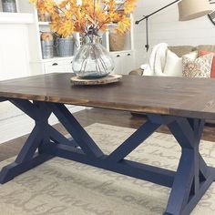 a wooden table sitting on top of a living room floor