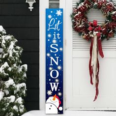 a christmas door hanger next to a wreath and snow covered front door with the words let it snow on it