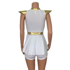 a female mannequin dressed in white with gold trimmings and short shorts