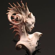 a sculpture of a woman's head with spikes on it