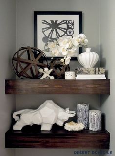 two shelves with various items on them in a room that is painted gray and white