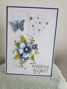 a card with blue flowers and butterflies on it