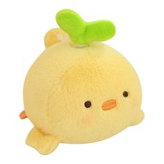 a yellow stuffed animal with a green leaf on it's head, sitting in front of a white background