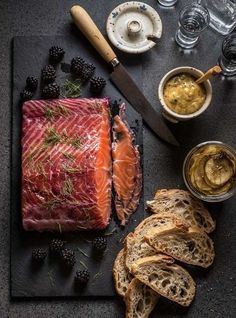 raw fish and bread on a cutting board