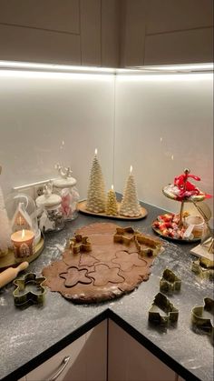 a kitchen counter topped with lots of cookies and other holiday treats on top of it