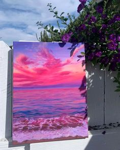 a painting on a white fence with purple flowers in the foreground