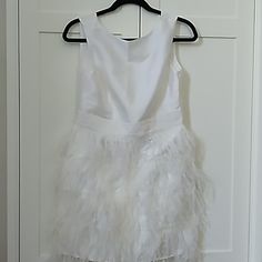 a white dress hanging on a door