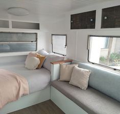 a bed sitting inside of a bedroom next to a window