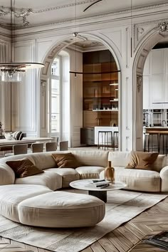 an elegant living room with white furniture and wood flooring