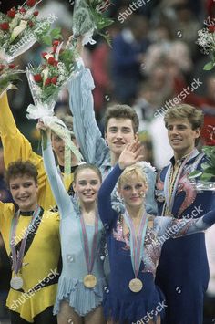 the us olympic team poses with their gold medals and bouquets after winning the bronze medal in the men's figure skating event