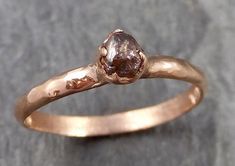 a gold ring with a brown diamond on it