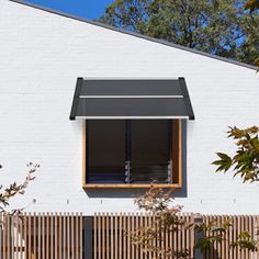 a white house with a wooden fence and window