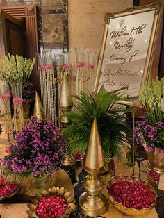 a table topped with lots of vases filled with flowers