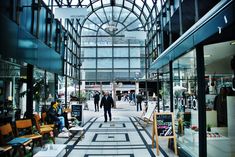 people are walking through an indoor shopping mall