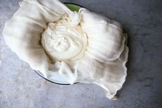 a bowl filled with whipped cream on top of a table